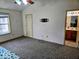 Main bedroom leading to ensuite bathroom, featuring plush carpet and natural light at 11521 Coastal Dr, Indianapolis, IN 46229