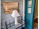 Charming porch decor, including a lighthouse lamp and starfish accents, next to an teal-colored entry door at 11521 Coastal Dr, Indianapolis, IN 46229