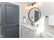 Charming half bath boasts modern lighting, round mirror, and a stylish vanity at 1234 S Talbott St, Indianapolis, IN 46225