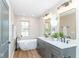 Bright bathroom features a soaking tub, double vanity with quartz counters, and modern fixtures at 1234 S Talbott St, Indianapolis, IN 46225