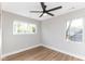 A room with two windows and wood-look flooring, and a dark-colored ceiling fan at 1234 S Talbott St, Indianapolis, IN 46225