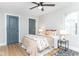 Cozy bedroom with large window, stylish ceiling fan, and decorative floral accents at 1234 S Talbott St, Indianapolis, IN 46225