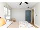 Bright bedroom with a ceiling fan and large windows providing ample natural light at 1234 S Talbott St, Indianapolis, IN 46225