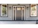 Elegant front door showcasing sidelights and a transom window, framed by modern light fixtures at 1234 S Talbott St, Indianapolis, IN 46225