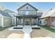 Charming two-story home featuring a covered front porch and modern architectural design at 1234 S Talbott St, Indianapolis, IN 46225