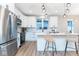 Modern kitchen with stainless steel appliances, white cabinetry, and a stylish island with seating at 1234 S Talbott St, Indianapolis, IN 46225