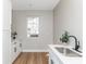 Bright laundry room with shaker cabinets, quartz counters and stainless sink at 1234 S Talbott St, Indianapolis, IN 46225