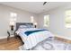Inviting bedroom with neutral colors, three windows, and hardwood floors at 1234 S Talbott St, Indianapolis, IN 46225