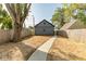 Backyard view featuring a walkway, new lawn, and privacy fence at 1234 S Talbott St, Indianapolis, IN 46225