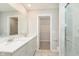 Bathroom featuring a double sink vanity, walk-in closet, and a modern glass-enclosed shower at 1274 Newton St, Avon, IN 46123