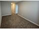 Spacious carpeted bedroom with neutral paint, base trim, and open doorway to hallway at 1274 Newton St, Avon, IN 46123