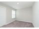 Minimalist bedroom with soft carpet and window offering natural light, creating a serene atmosphere at 1274 Newton St, Avon, IN 46123