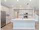 Modern kitchen featuring white cabinets, stainless appliances, an island, and hardwood floors at 1274 Newton St, Avon, IN 46123