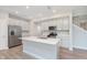 Modern kitchen featuring white cabinets, stainless appliances, an island, and hardwood floors at 1274 Newton St, Avon, IN 46123