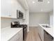 Modern kitchen featuring white cabinets, stainless appliances, granite countertops, and hardwood floors at 1274 Newton St, Avon, IN 46123