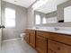 Bathroom with a double vanity, tiled floor, large mirror, and a window at 1299 Timber Bluff Rd, Westfield, IN 46074