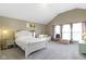 Spacious primary bedroom with neutral carpet, a white bed, and an adjacent sitting area at 1299 Timber Bluff Rd, Westfield, IN 46074