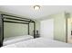 Bright bedroom features two beds, light green walls, and a black canopy bed frame at 1299 Timber Bluff Rd, Westfield, IN 46074