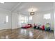 Bright and airy bonus room featuring hardwood floors and a fun play area at 1299 Timber Bluff Rd, Westfield, IN 46074