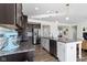 Open-concept kitchen with stainless steel appliances, granite countertops, and dark wood cabinets at 1299 Timber Bluff Rd, Westfield, IN 46074
