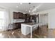 Bright and airy kitchen with dark cabinets, stainless steel appliances, a large island, and hardwood floors at 1299 Timber Bluff Rd, Westfield, IN 46074