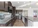 Modern kitchen with stainless steel appliances, granite countertops, and dark wood cabinets at 1299 Timber Bluff Rd, Westfield, IN 46074