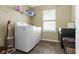 Bright laundry room featuring a washer and dryer, with natural light from a window at 1299 Timber Bluff Rd, Westfield, IN 46074