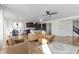 Open-concept living room with hardwood floors, a leather sofa, and seamless transition to the dining area and kitchen at 1299 Timber Bluff Rd, Westfield, IN 46074