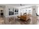 Comfortable living room with a fireplace, built-in shelving, large windows, and a stylish leather sectional sofa at 1299 Timber Bluff Rd, Westfield, IN 46074