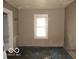 Dilapidated bedroom features peeling paint, carpet and natural light at 1310 E 5Th St, Muncie, IN 47302