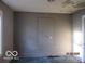 Dilapidated bedroom features peeling paint, carpet and natural light at 1310 E 5Th St, Muncie, IN 47302
