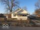 Modest home featuring striped awnings over the windows at 1310 E 5Th St, Muncie, IN 47302