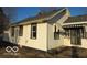 Side view of a home with white siding, dark window trim, and striped awnings at 1310 E 5Th St, Muncie, IN 47302