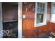 Dilapidated interior view with broken window and peeling paint at 1310 E 5Th St, Muncie, IN 47302