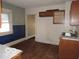 Dilapidated kitchen features aging cabinets, double basin sink and damaged flooring at 1310 E 5Th St, Muncie, IN 47302