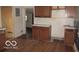 Kitchen with cabinets, peeling paint, and damaged walls at 1310 E 5Th St, Muncie, IN 47302