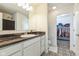 Bathroom features a vanity with black countertop, decorative tile floor, and a closet at 1381 Delacorte Cir, Shelbyville, IN 46176