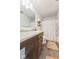 Bright bathroom features a vanity with solid surface countertop, decorative shelving, and a shower/tub combination at 1381 Delacorte Cir, Shelbyville, IN 46176
