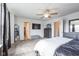 Bright bedroom featuring a ceiling fan, walk-in closet, and ensuite bathroom at 1381 Delacorte Cir, Shelbyville, IN 46176