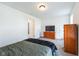 Carpeted bedroom featuring a TV, closet, and dresser at 1381 Delacorte Cir, Shelbyville, IN 46176