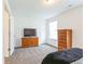 Carpeted bedroom featuring a TV, closet, and dresser at 1381 Delacorte Cir, Shelbyville, IN 46176