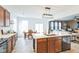 Open dining area with a table, access to a patio, and seamless flow into the kitchen and living spaces at 1381 Delacorte Cir, Shelbyville, IN 46176