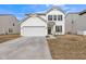Charming two-story home with a white exterior, a well-kept lawn, and a spacious two-car garage at 1381 Delacorte Cir, Shelbyville, IN 46176