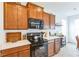 Contemporary kitchen with modern appliances, light countertops, and warm wood cabinetry at 1381 Delacorte Cir, Shelbyville, IN 46176