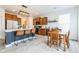 Modern kitchen features an island with seating, stainless steel appliances, and an adjacent dining area at 1381 Delacorte Cir, Shelbyville, IN 46176