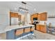 Bright kitchen featuring a large island with seating, warm wood cabinets, and modern appliances at 1381 Delacorte Cir, Shelbyville, IN 46176