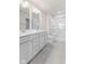 Bright bathroom featuring double sinks, shower and toilet; light gray tile flooring complements the decor at 140 Mission Terrace Dr, Whiteland, IN 46184