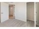 View of a carpeted bedroom with white walls and trim, and white doors to the closet and hall at 140 Mission Terrace Dr, Whiteland, IN 46184