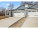 New construction home featuring blue siding, a gray stone accent and a two-car garage with a concrete driveway at 140 Mission Terrace Dr, Whiteland, IN 46184