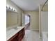 Full bathroom with marble vanity and tiled bathtub at 14457 Orange Blossom Trl, Fishers, IN 46038